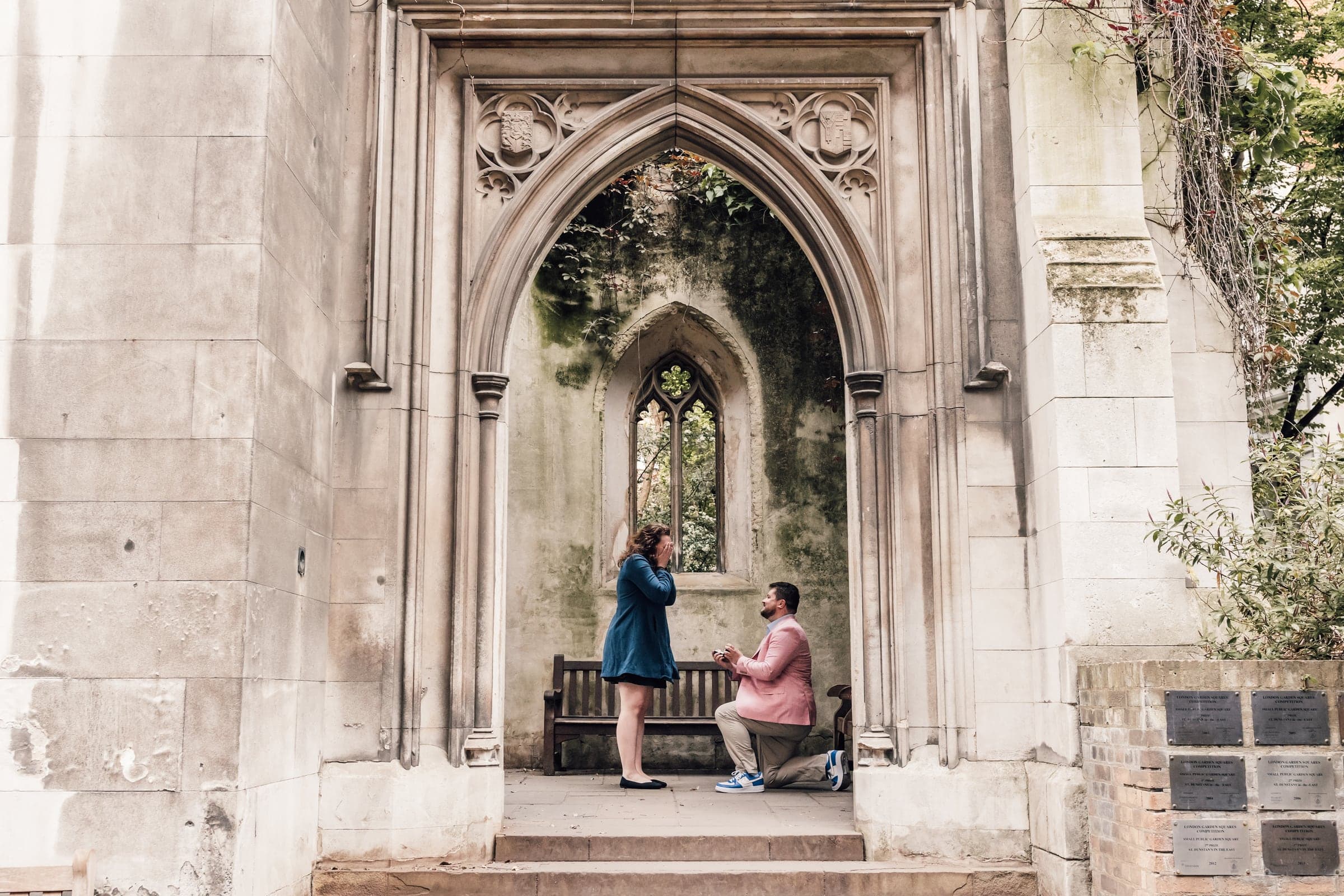 Rory proposing to Sara beneath a stone arch